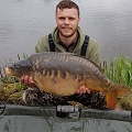 HERE IS JAMES TUDOR WITH A 28LB MILLBROOK MIRROR,CAUGHT FROM PEG 1.
