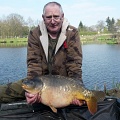 HERE IS NORMAN WHITTER WITH A 22LB MIRROR CAUGHT FROM PEG 12